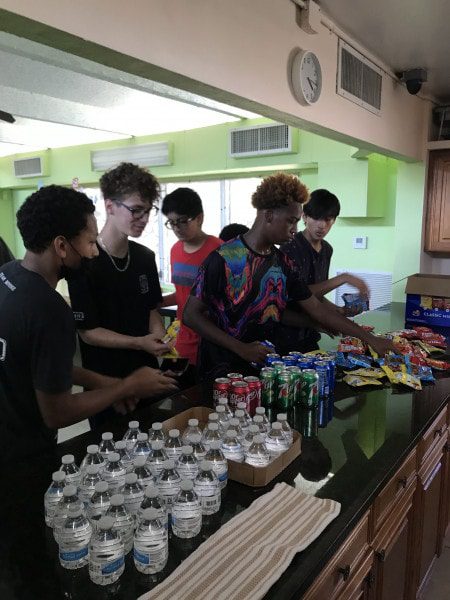 Group of teenage boys preparing snacks