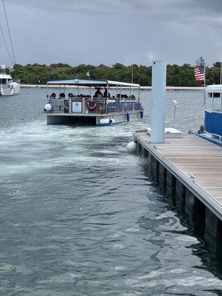 the shuttle boat taking off from the pier